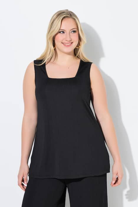 Débardeur côtelé. Décolleté carré. Bretelles larges. Coupe évasée