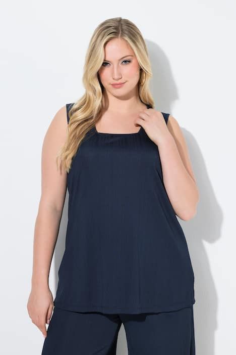 Débardeur côtelé. Décolleté carré. Bretelles larges. Coupe évasée