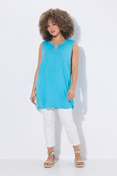 Top long sans manches, décolleté en V avec passepoils et col légèrement montant