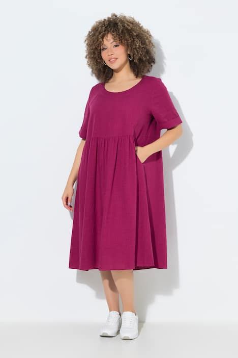 Robe en lin mélangé. Encolure ronde et manches courtes. Coupe évasée