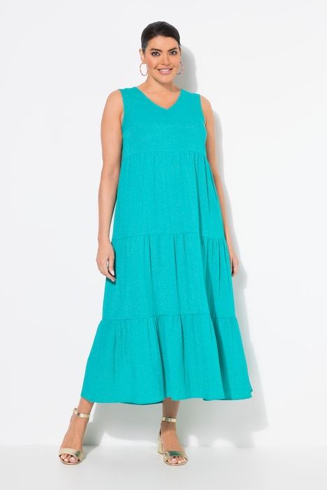 Robe maxi sans manches. Plusieurs niveaux de volants. Décolleté V. Coupe évasée