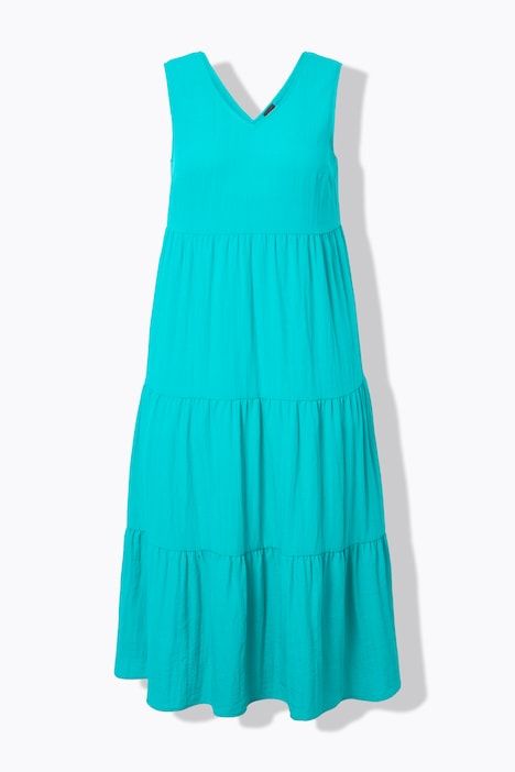 Robe maxi sans manches. Plusieurs niveaux de volants. Décolleté V. Coupe évasée